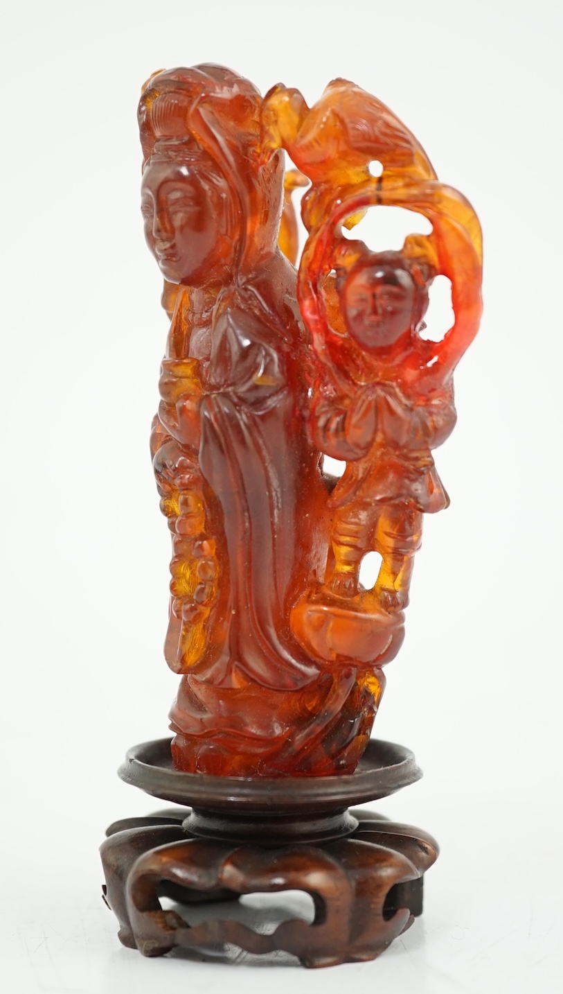 A Chinese amber group of Guanyin, 19th century, small losses